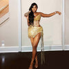 Woman Wearing a Gold Glitter Rhinestone Tassel Mini Birthday Dress with Sparkling Fringe and Embellishments, Styled for Luxe Celebrations