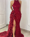 Woman wearing red sequin mermaid evening dress with halter neckline